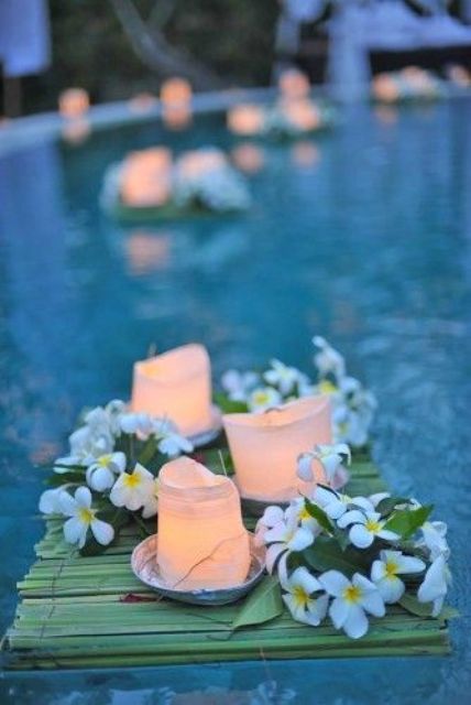 floating bambbo mats with fresh flowers and candles