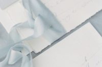 19 neutral wedding invitations with light blue ribbon