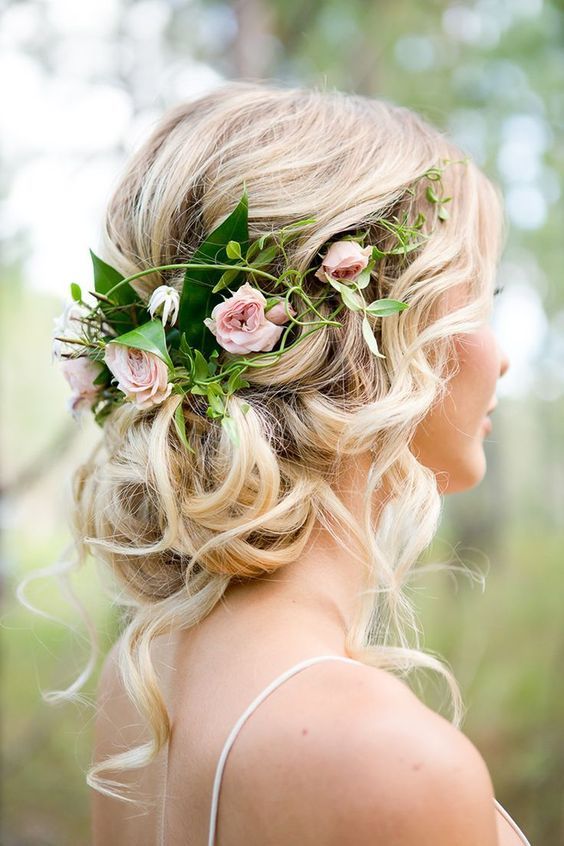 updo with fresh garden roses and greenery and lots of locks hanging