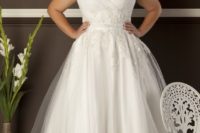 21 plus-size bejeweled wedding dress with cap sleeves aand a sweetheart neckline