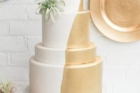25 half gold and half white wedding cake with air plant decor for a modern wedding