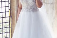 26 V-neck wedding dress with a heavily beaded bodice and a plain tulle skirt