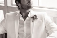 27 an all-white look with a suit and a shirt, a bold boutonniere