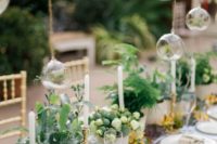 28 tiny hanging terrariums with air plants over the reception