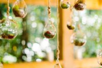 29 tiny hanging terrariums over the reception