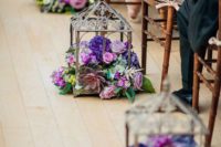 31 terrariums filled with super bold florals for lining up the aisle
