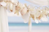 32 a garland of seashells accents the wedding chuppah