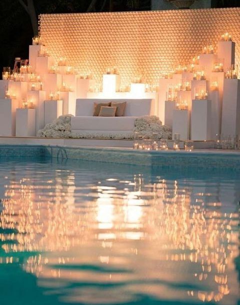 outdoor lounge in white with baby's breath and candles