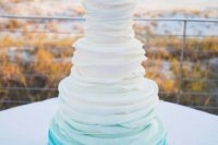 34 ruffle ombre wedding cake in shades of blue and a sparkling cake topper