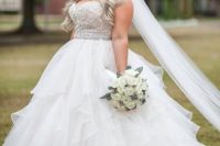 34 strapless empire waist wedding dress with a jeweled bodice and a ruffled skirt