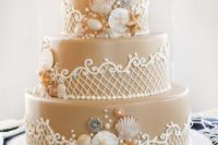 35 sand-colored wedding cake with shells and star fish
