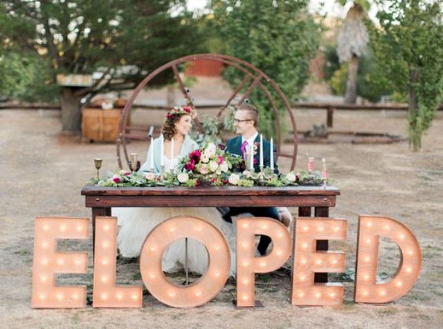 industrial wedding, a sweetheart table with ELOPED letters