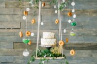 36 suspended cake display with greenery, donuts and candies for a fun touch