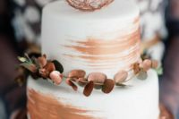 36 white wedding cake with copper leaf decor and a copper sphere
