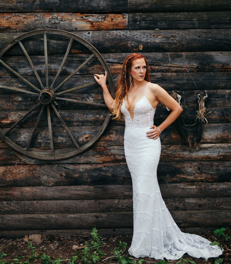 The bride chose a dress by Berta Bridals with spaghetti straps and a plunging neckline