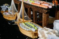 03 a creative sushi bar with food in ships and on wooden stands