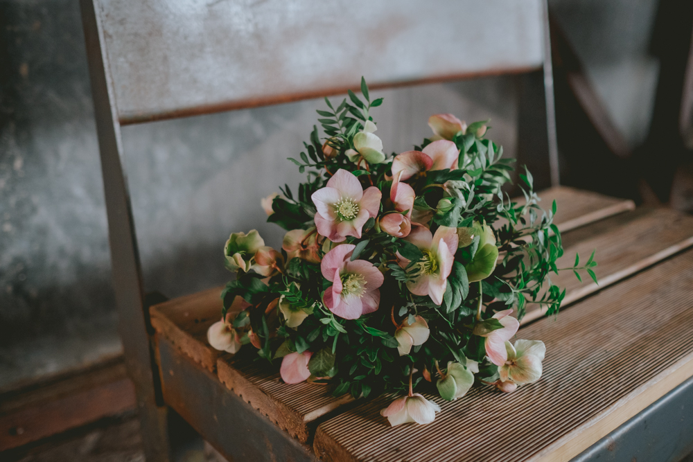 The bride was rocking a simple greenery and pink bloom bouquet