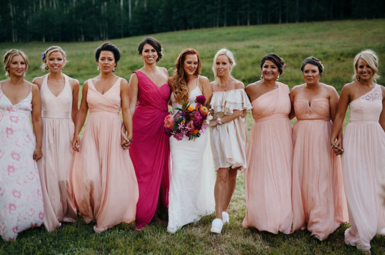 The bridesmaids were wearing mismatching dresses, blush, floral and neutral ones