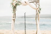 04 driftwood wedding arch with ethereal fabrics and neutral florals