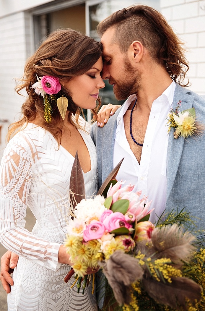 Colorful tropical flowers and feathers gave the shoot a cool boho-inspired look