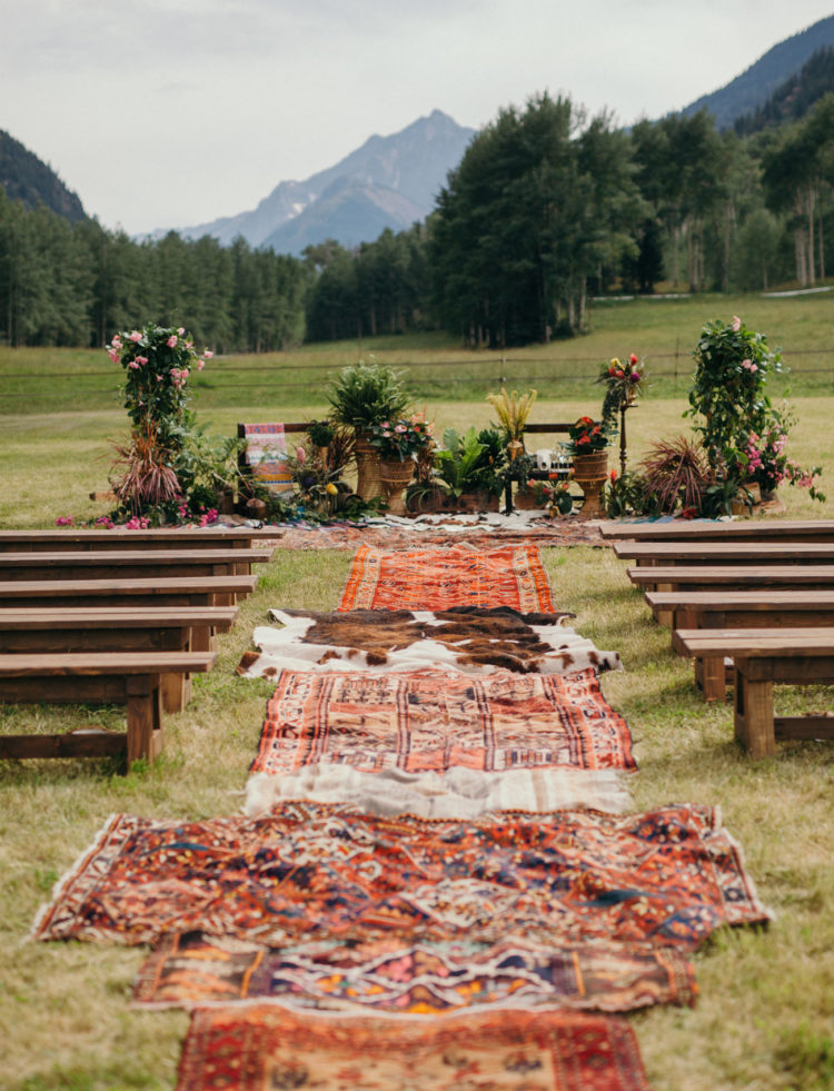 The ceremony spot was decorated with greenery and flowers and covered with rugs that bride had brought from her trips