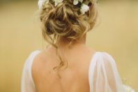 06 a messy updo with white flowers tucked in looks very summer-like