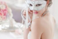 06 a white lace and rhinestone mask for the bride looks gorgeous