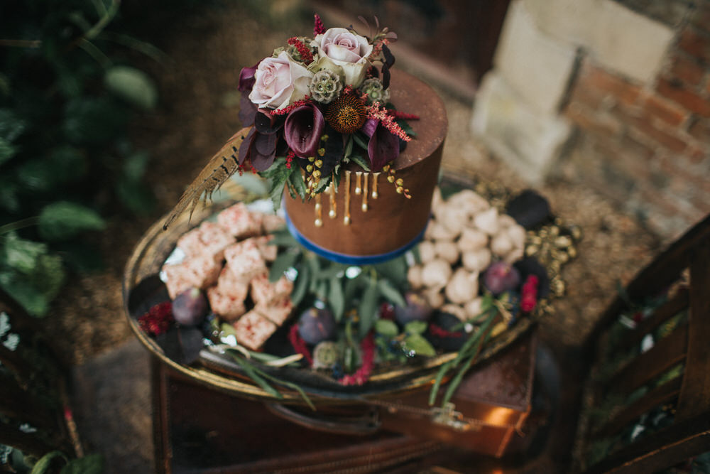 The wedding cake was done in brown with drip, which is a hot trend, and topped with moody flowers