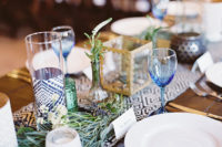 08 The wedding tablescapes were decorated with textile table runners, glass vases, candle holders, air plants and greenery
