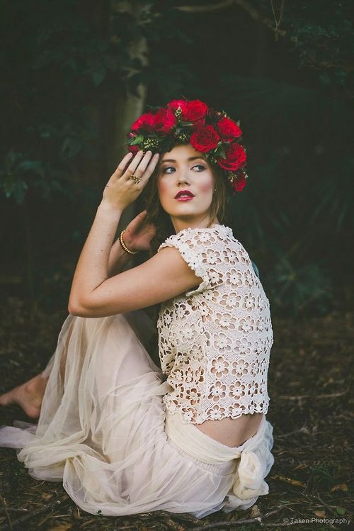 an ivory flowing skirt and a crochet lace top with short sleeves, a bold flower crown