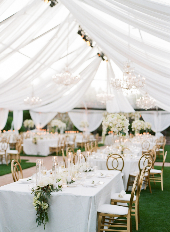 Lot of glam chandeliers were used to enlighten the wedding tent
