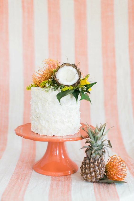 textural wedding cake with greenery and a coconut