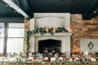 10 The wedding tablescape was decorated with eucalyptus, candles and a fireplace added coziness
