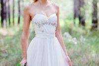 10 a white wedding dress on spaghetti straps with a rhinestone bodice and a leaf and floral crown