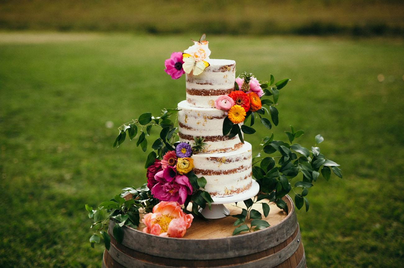 The cake was a naked one and topped with fresh flowers and leaves
