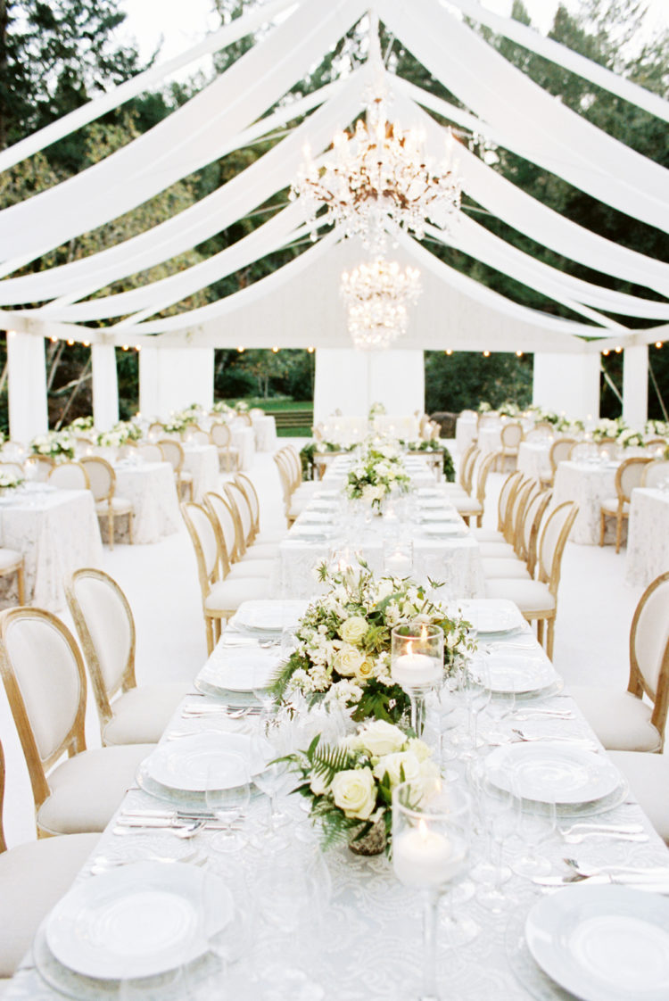The wedding reception was covered with draped fabric cover, glam chandeliers