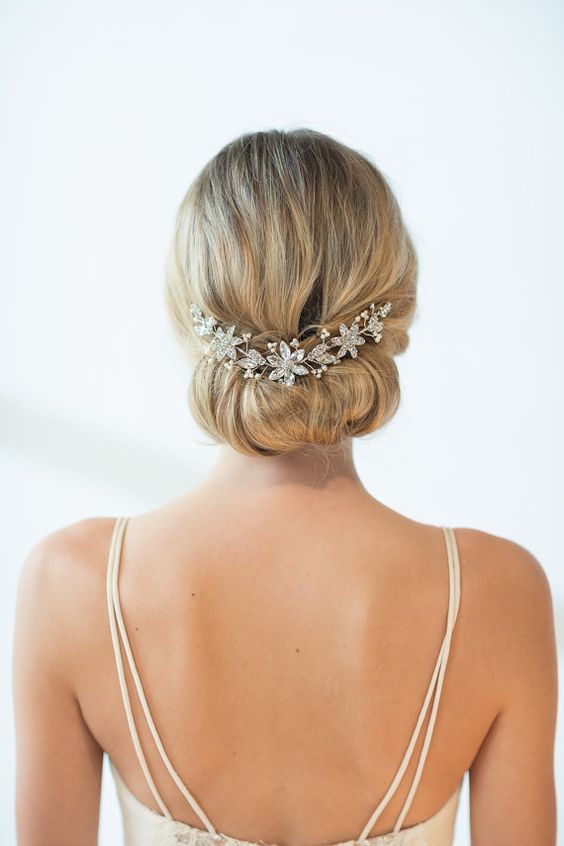 a simple updo with a crystal hair vine of silver flowers