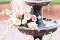 13 a fountain with lush flowers is right what you need for a refined summer garden affair