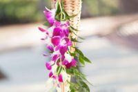 13 a torch with bold purple orchids and greenery