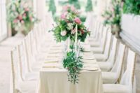15 neutral wedding tablescape with lots of greenery and candles
