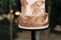 15 white cake decorated with copper edible palm leaves and stripes