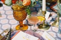 16 super bold and colorful table setting with feathers and candles for a boho fete