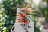 18 a simple cake with tropical flowers and greenery decor