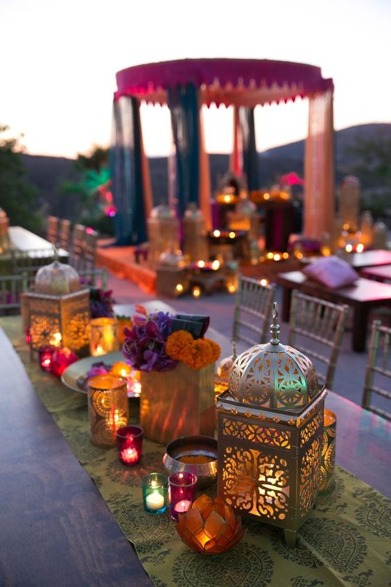 a printed table runner with lots of candles and lanterns