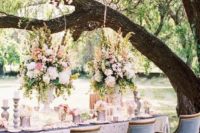 19 formal garden wedidng reception with a sequin tablecloth and blue chairs