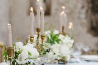 19 soft blue wedding tablescape with gilded candle holders and ivory flowers