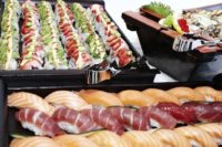 21 fresh sushi selection on black metal stands