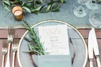 22 a clear, gold-rim plates set with menus doubling as place cards graced each seat, olive green shades