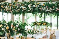 23 indoor summer wedding reception with lush flower decor over the tables