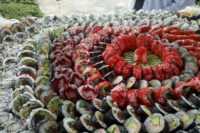 23 lush sushi station with all kinds of sushi placed on each other